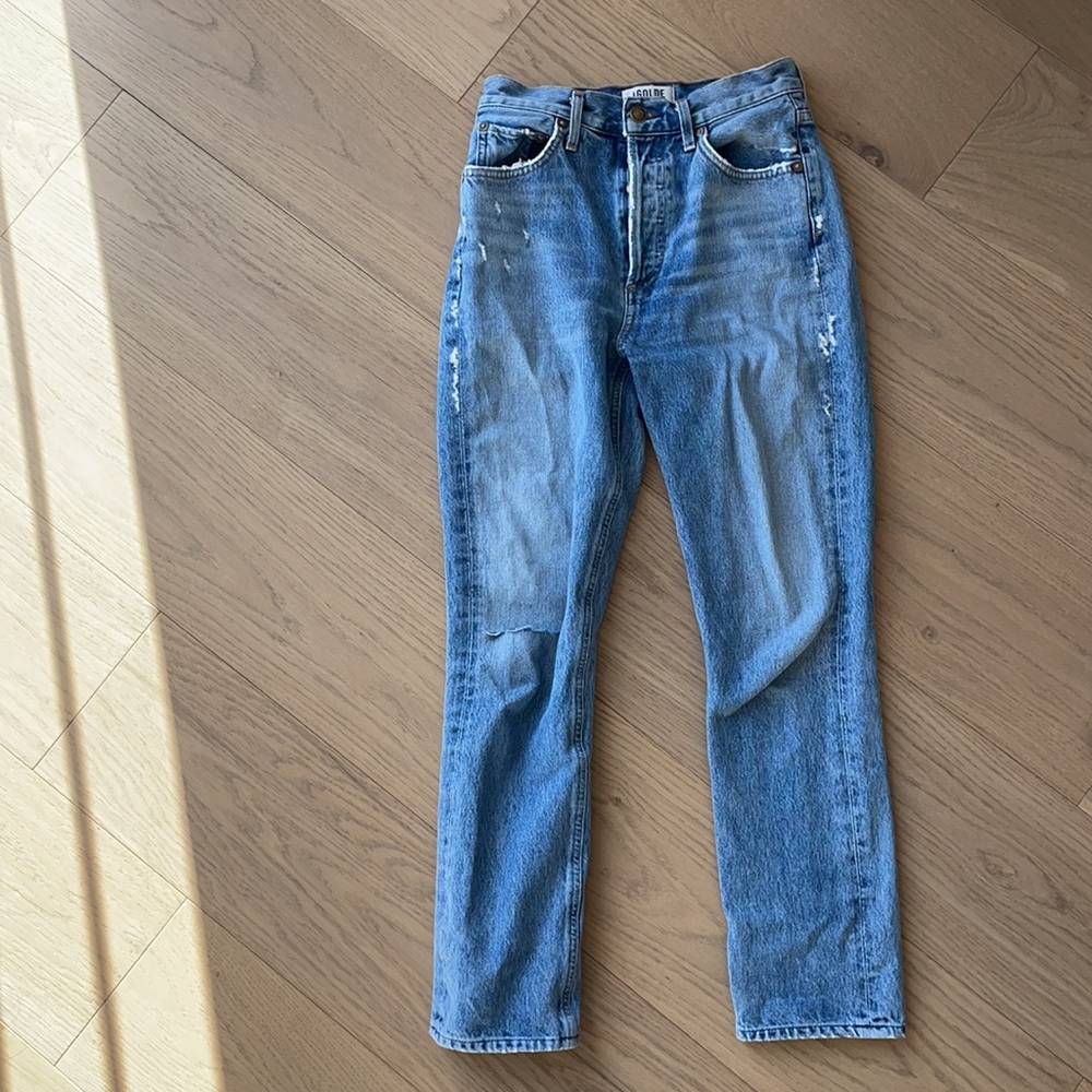 Agolde Riley cropped light wash jeans with a rip above the knee